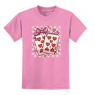 Youth pink cotton t-shirt featuring the six and seven of hearts playing cards tied with a bow and heart accents