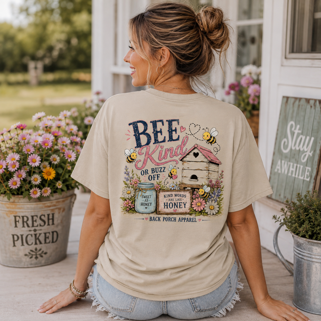 Woman wearing a Bee Kind or Buzz Off Back Porch Apparel Shirt