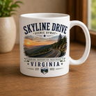 11oz white ceramic Skyline Drive Virginia coffee mug featuring a scenic mountain roadway design, handcrafted by Turnmeyers in Front Royal, Virginia.