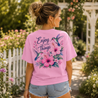 Woman wearing an Enjoy The Little things Hummingbird Back Porch Apparel Shirt