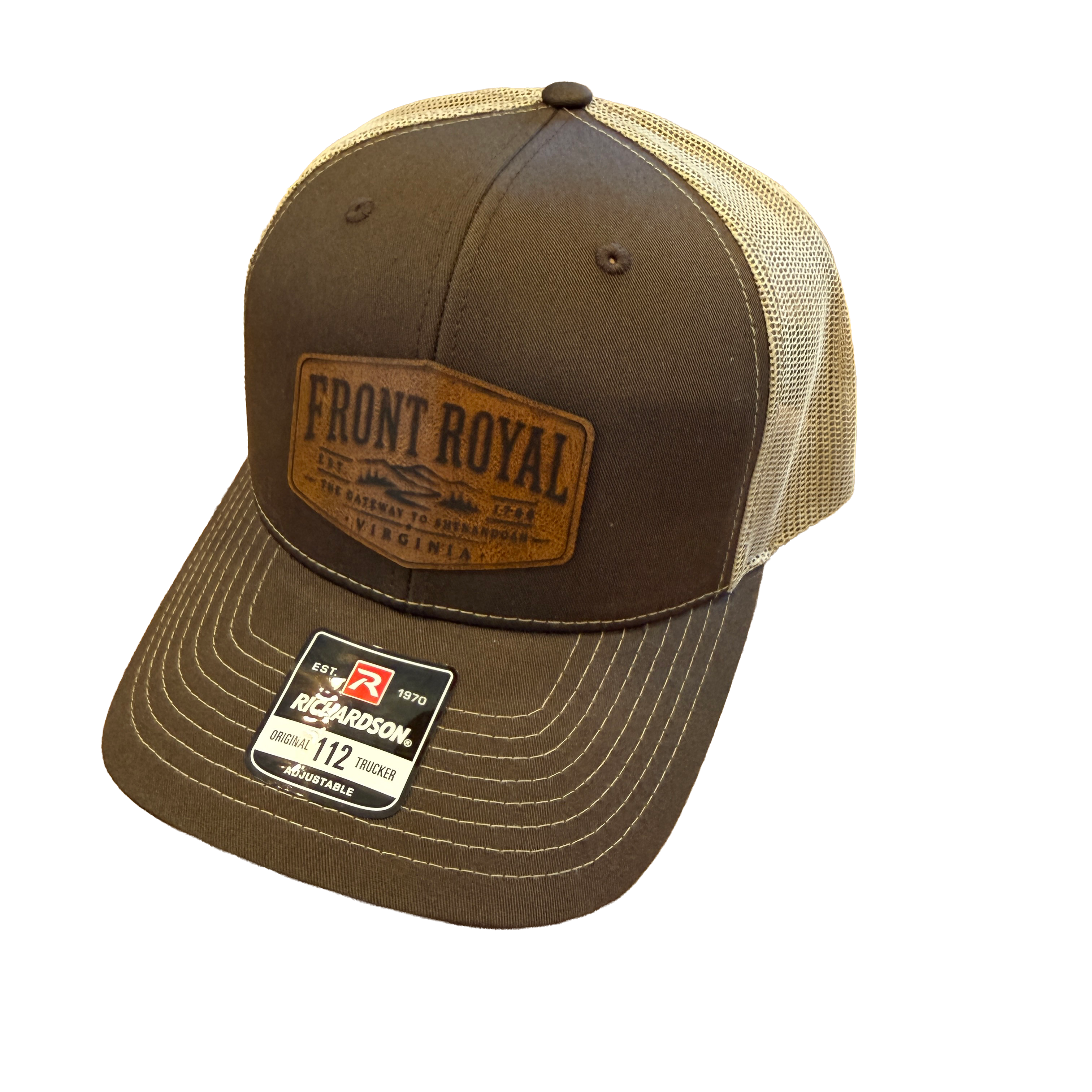 Front Royal Virginia leather patch Richardson 112 trucker hat with brown front panels, tan mesh back, and engraved leather patch on a transparent background.