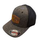 Front Royal Virginia leather patch Flexfit trucker hat with heather charcoal front panels, black mesh back, and engraved leather patch on a transparent background.