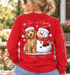 Woman modeling a red Simply Southern Let It Snow long sleeve shirt featuring a Christmas dog and snowman graphic on the back.