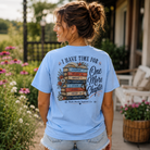 Woman wearing a One More Chapter Book from Back Porch Apparel Shirt