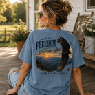 Woman wearing a Rooted In Freedom Back Porch Apparel Shirt