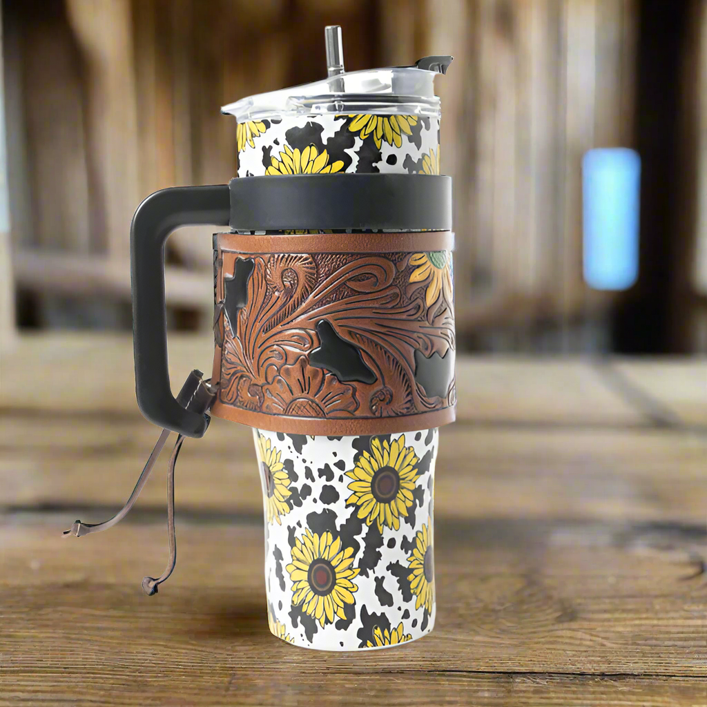 Myra Wide Wyoming 40oz Stainless Steel Tumbler Black and White Cow with Sunflowers and Hand Tooled Leather