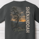 Close-up of Shenandoah Virginia sunset graphic on Comfort Colors Pepper t-shirt with Blue Ridge mountain landscape and vintage typography.