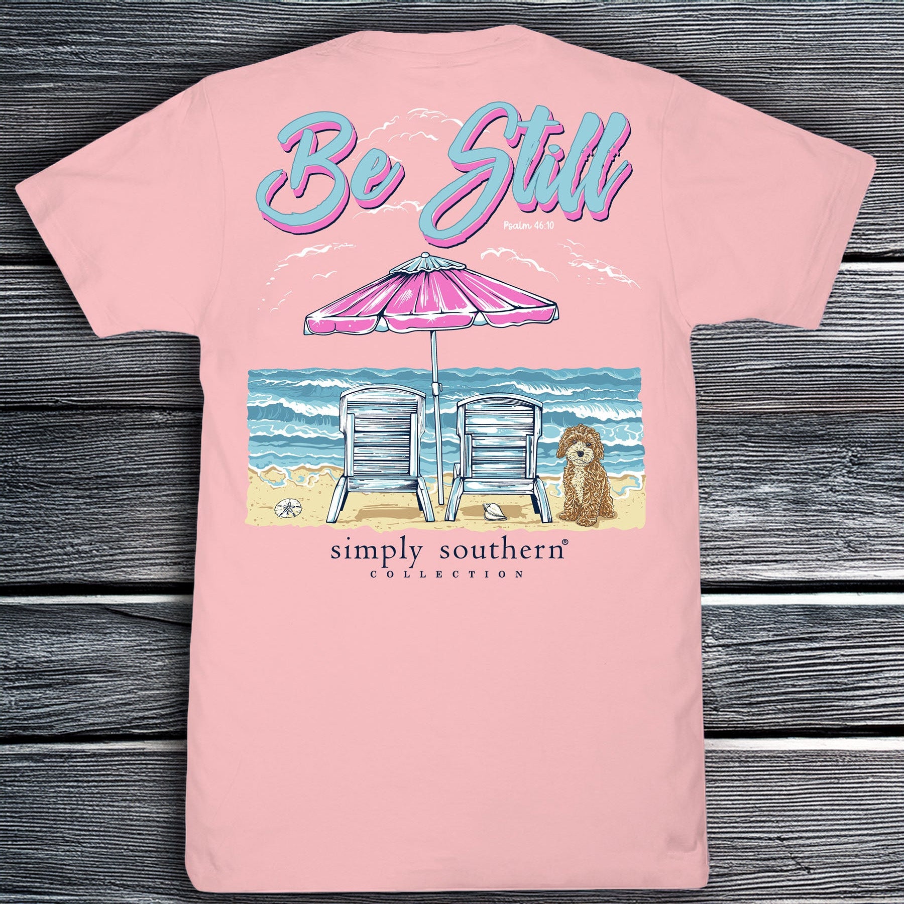 Simply Southern Be Still pink short sleeve cotton tee with beach chairs, umbrella, ocean waves, and dog graphic