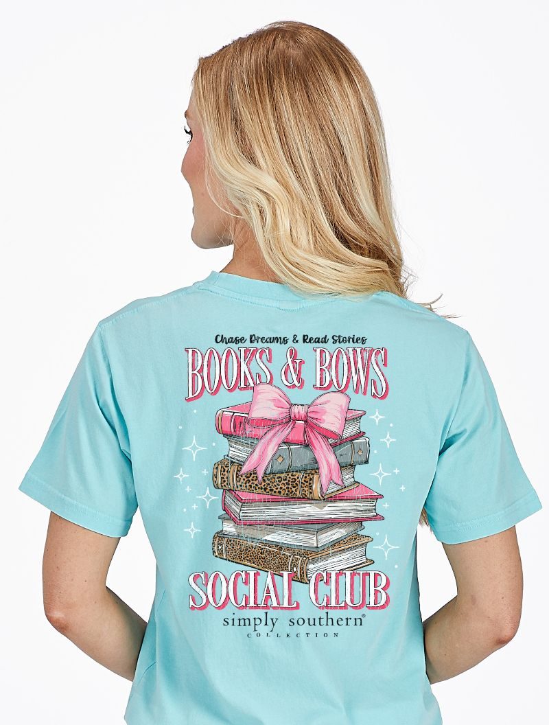 Model wearing Simply Southern Books and Bows Social Club t-shirt showing book stack and bow design on back