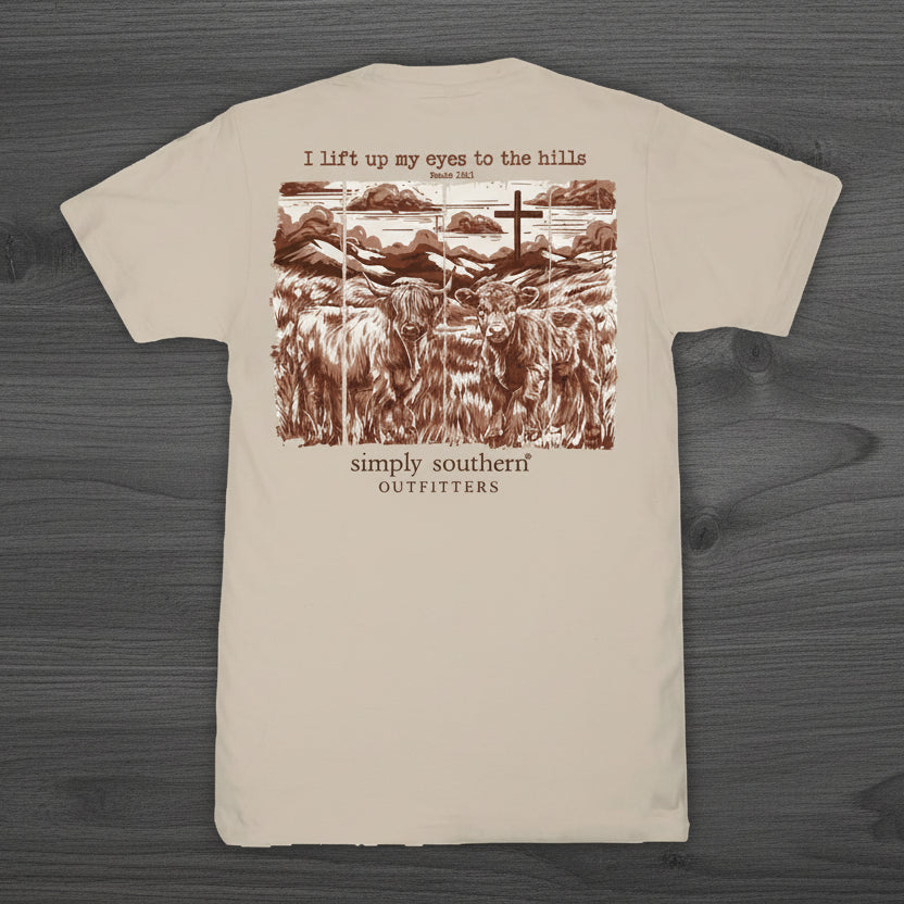 Simply Southern clay short sleeve t-shirt featuring Highland cows, hills, cross, and Psalm 121:1 “I lift up my eyes to the hills” back graphic