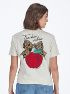 Model wearing Simply Southern Teacher Vibes t-shirt showing apple and camo bow back design