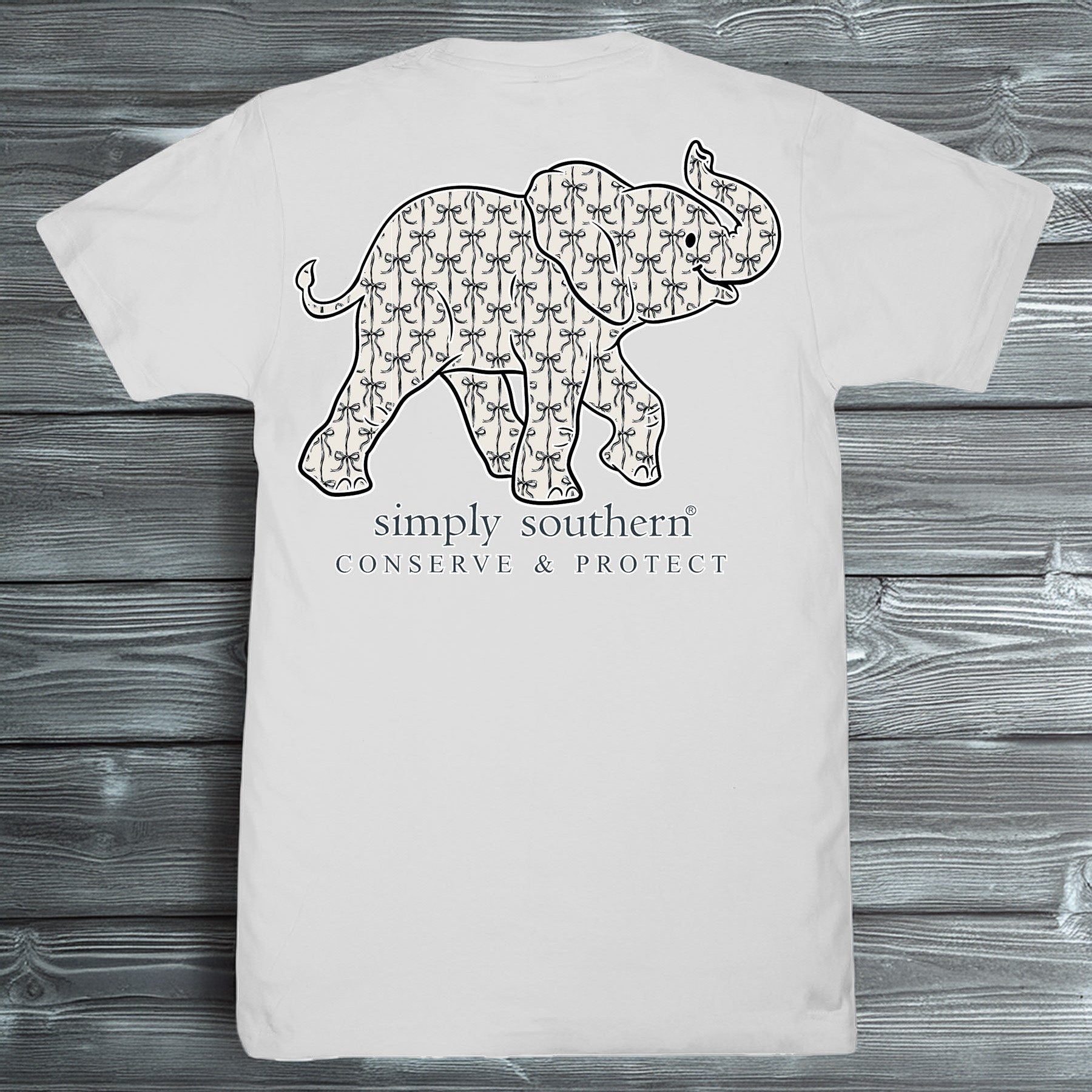 Simply Southern Conserve & Protect elephant graphic with bow pattern on light-colored short sleeve t-shirt