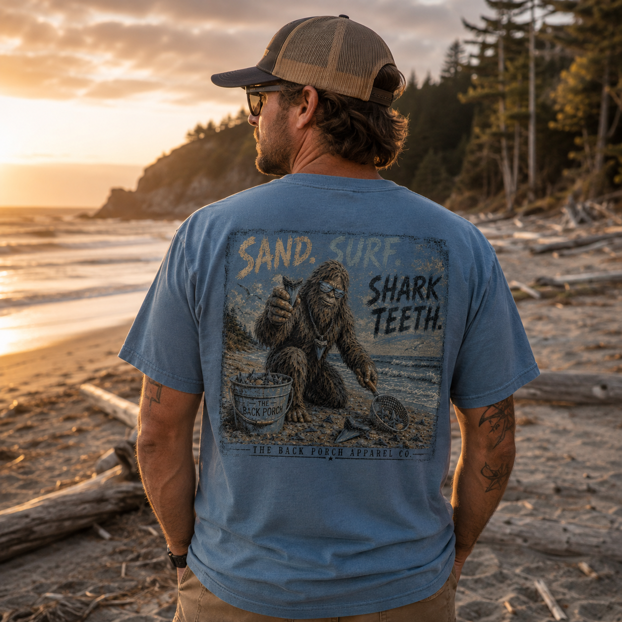 Man wearing a Sand Surf Shark Teeth Bigfoot Back Porch Apparel shirt