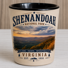 Ceramic Shenandoah National Park shot glass featuring a sunset view from Hogback Overlook with vintage-style typography and black interior.