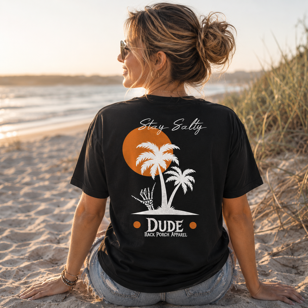 Woman wearing a Stay Salty Back Porch Apparel Shirt