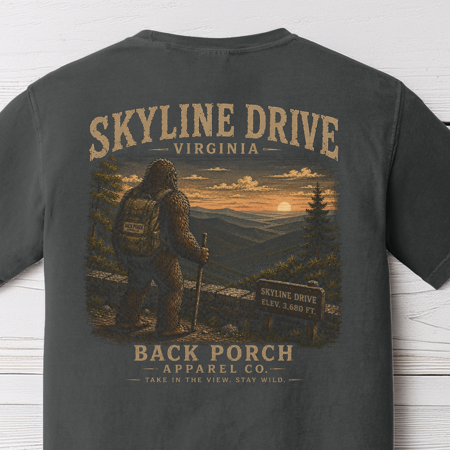 Skyline Drive Bigfoot graphic t-shirt on Comfort Colors garment-dyed tee featuring Sasquatch overlooking the Blue Ridge Mountains