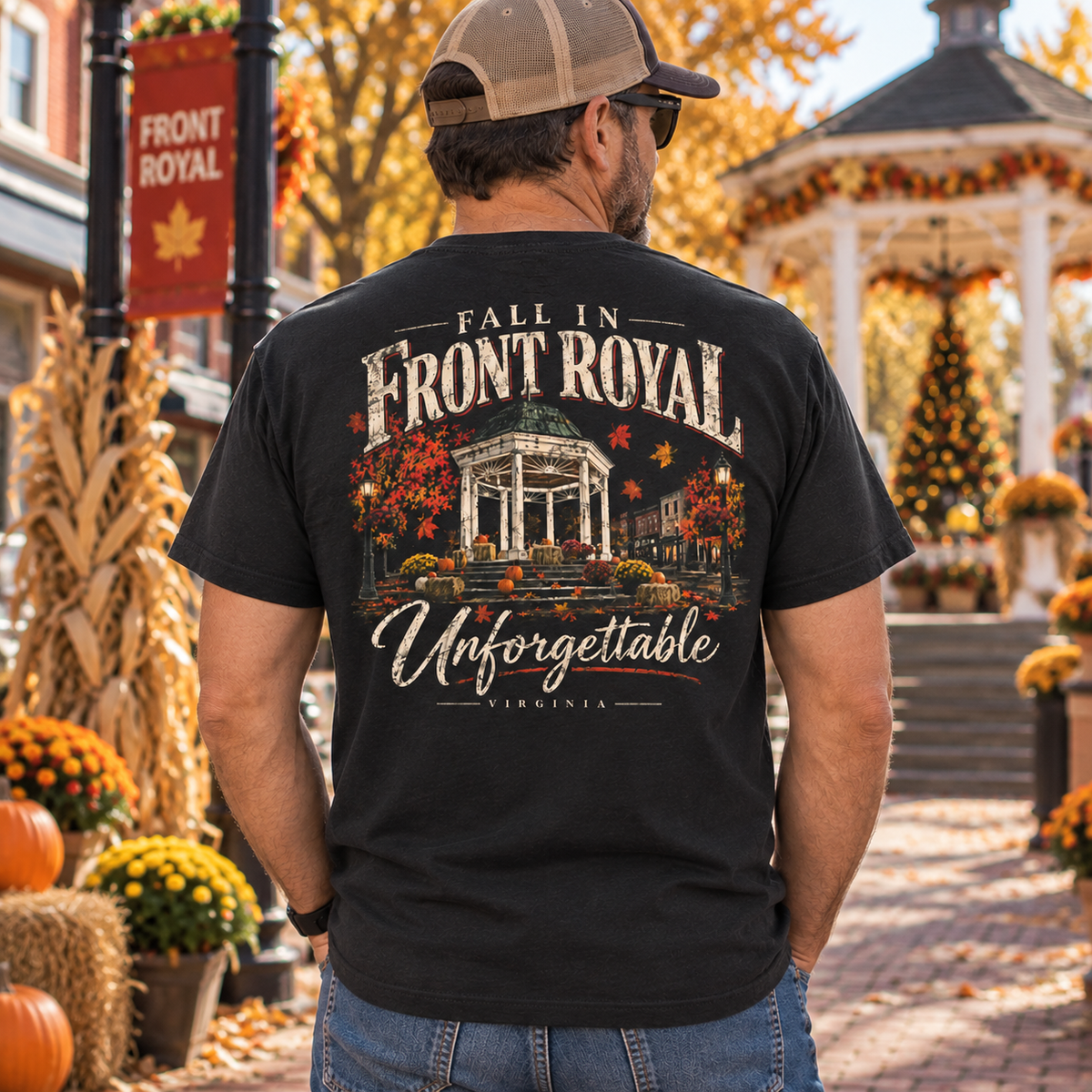 Man wearing a Fall in Front Royal Virginia Comfort Colors T-shirt in a decorated autumn town setting near the gazebo.