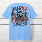 'Merica Feral and Free patriotic raccoon graphic t-shirt featuring a raccoon wearing American flag sunglasses, holding a U.S. flag, and celebrating America's 250th Anniversary