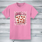 Youth pink cotton t-shirt featuring the six and seven of hearts playing cards tied with a bow and heart 