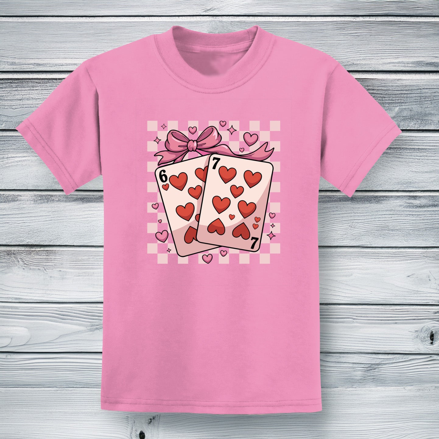 Youth pink cotton t-shirt featuring the six and seven of hearts playing cards tied with a bow and heart 