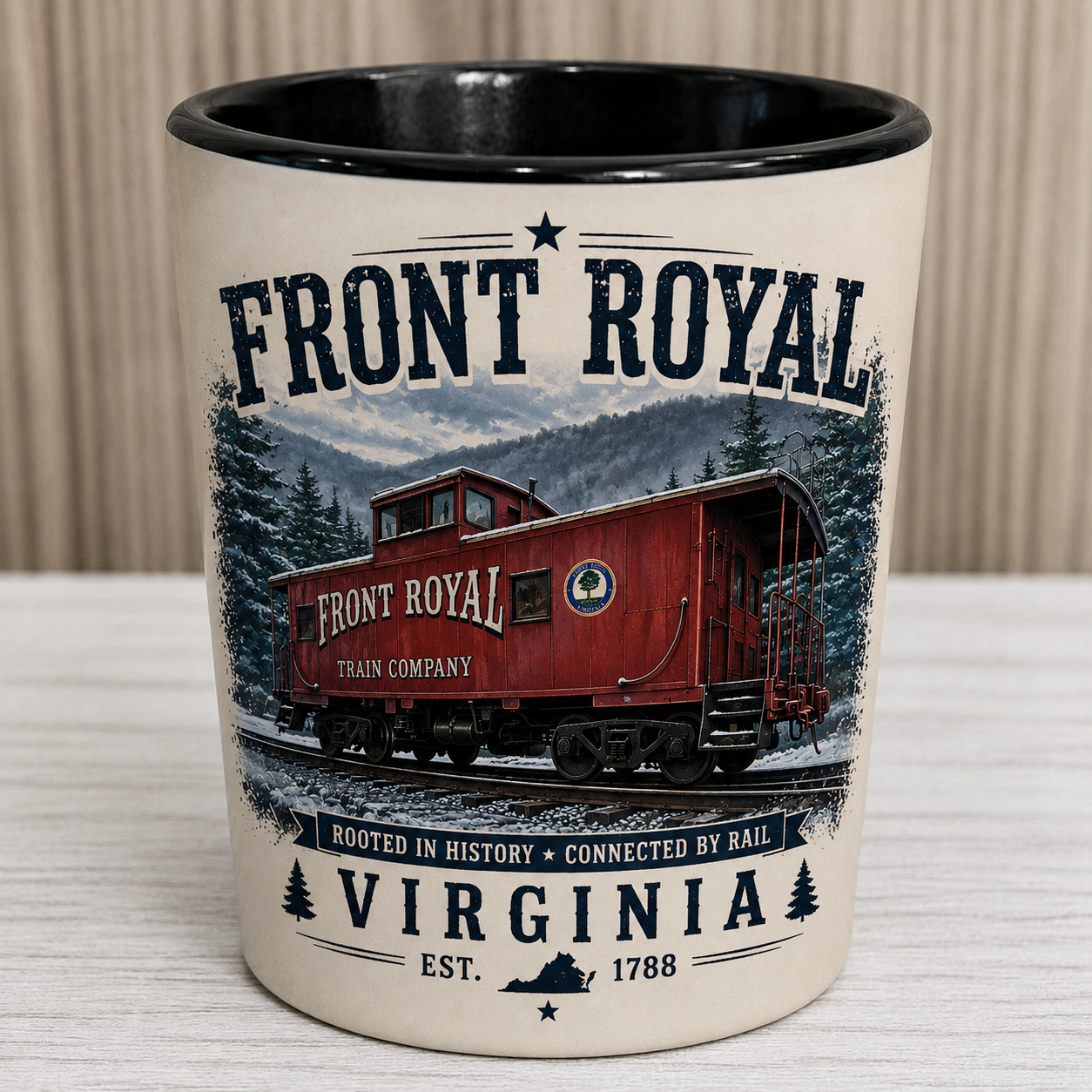 Front Royal Virginia ceramic shot glass featuring a vintage illustration of the historic Front Royal Train Company caboose against the Blue Ridge Mountains with distressed patriotic typography and black interior.