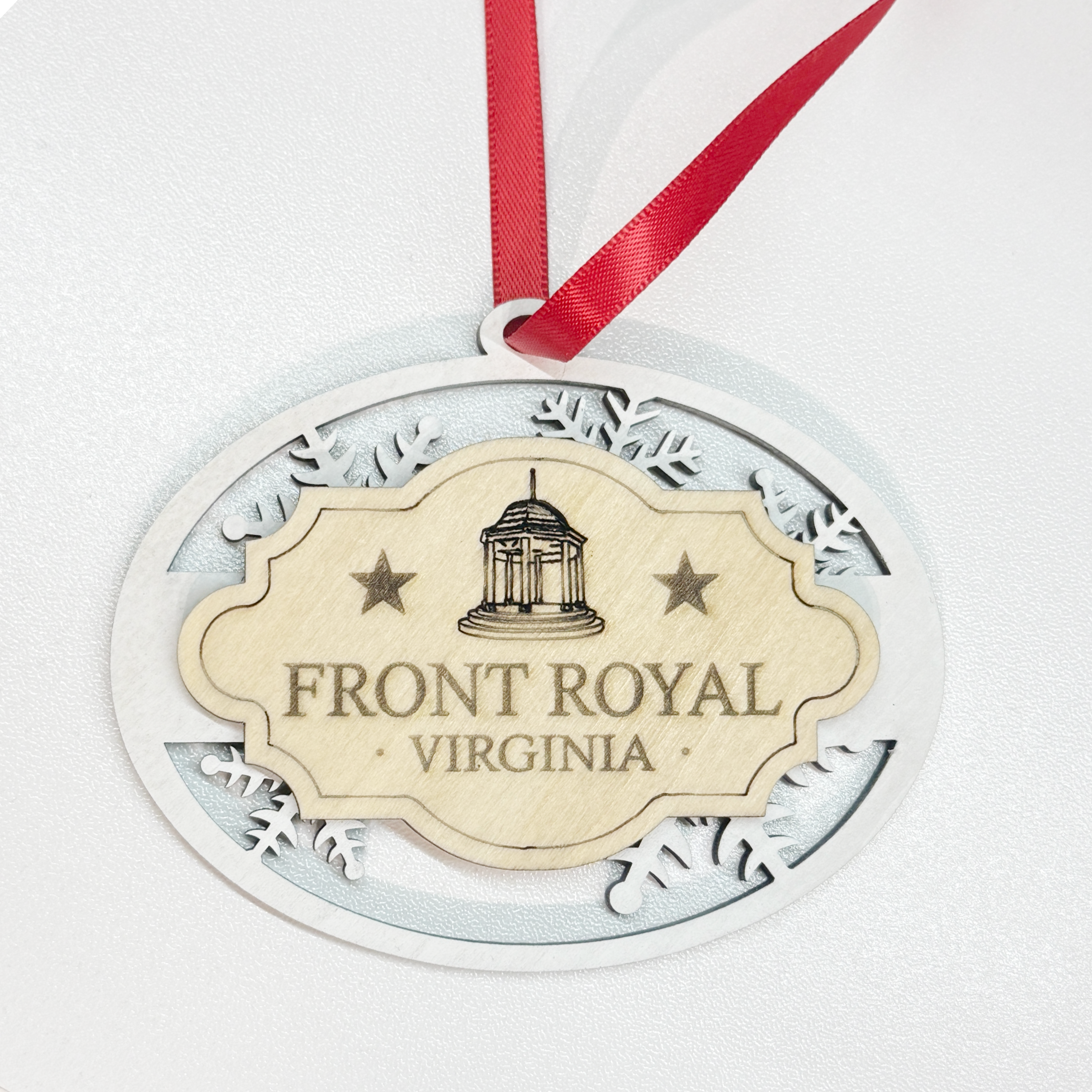 Front Royal Virginia layered wood snowflake ornament with engraved gazebo design, white snowflake frame, natural wood center, and red hanging ribbon.