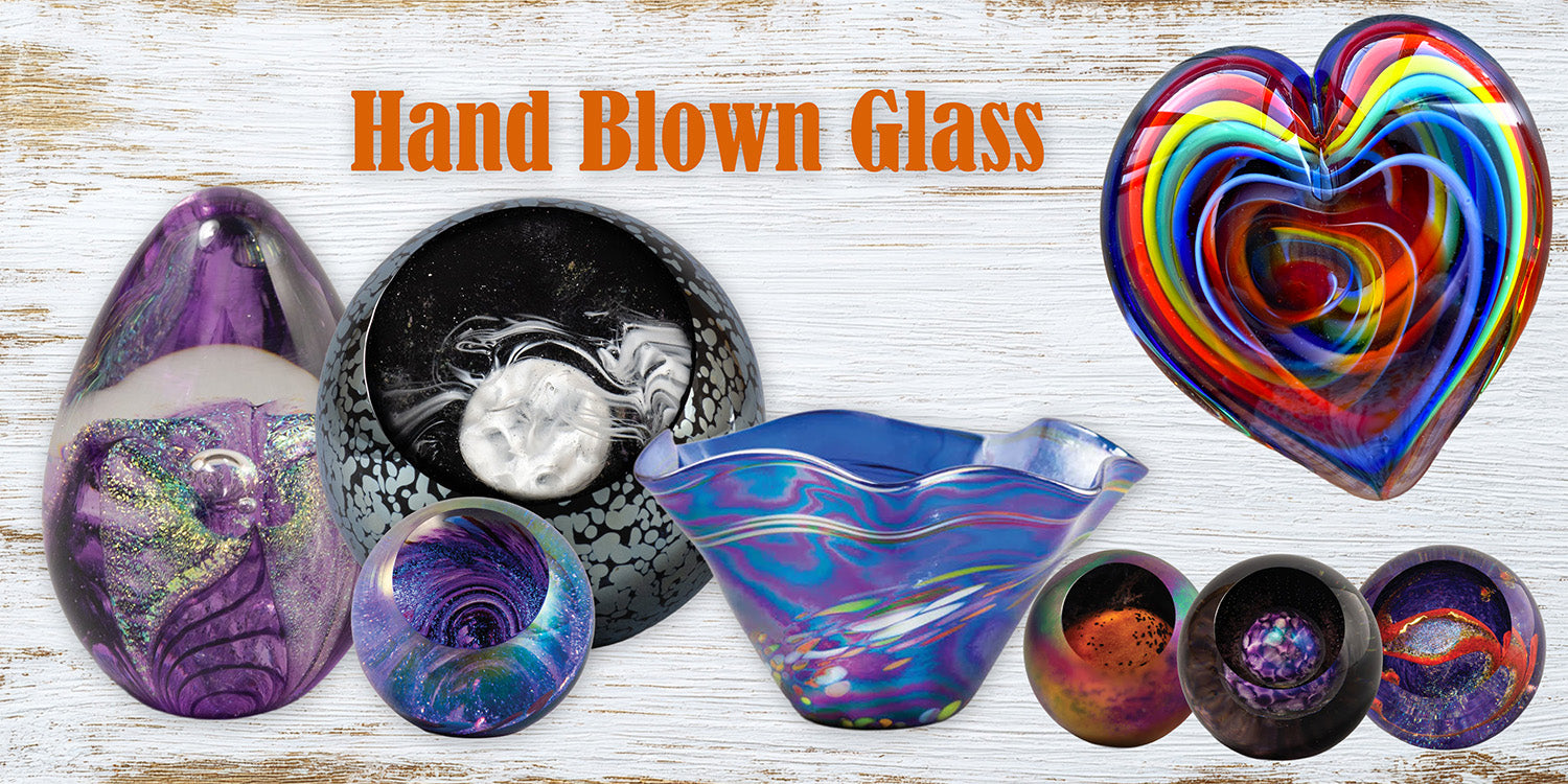 Hand-blown art glass sculptures displayed together, showcasing rich color, texture, and artisan craftsmanship