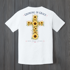 Growing In Grace graphic t-shirt featuring a large sunflower cross with floral accents and Christian faith-inspired artwork
