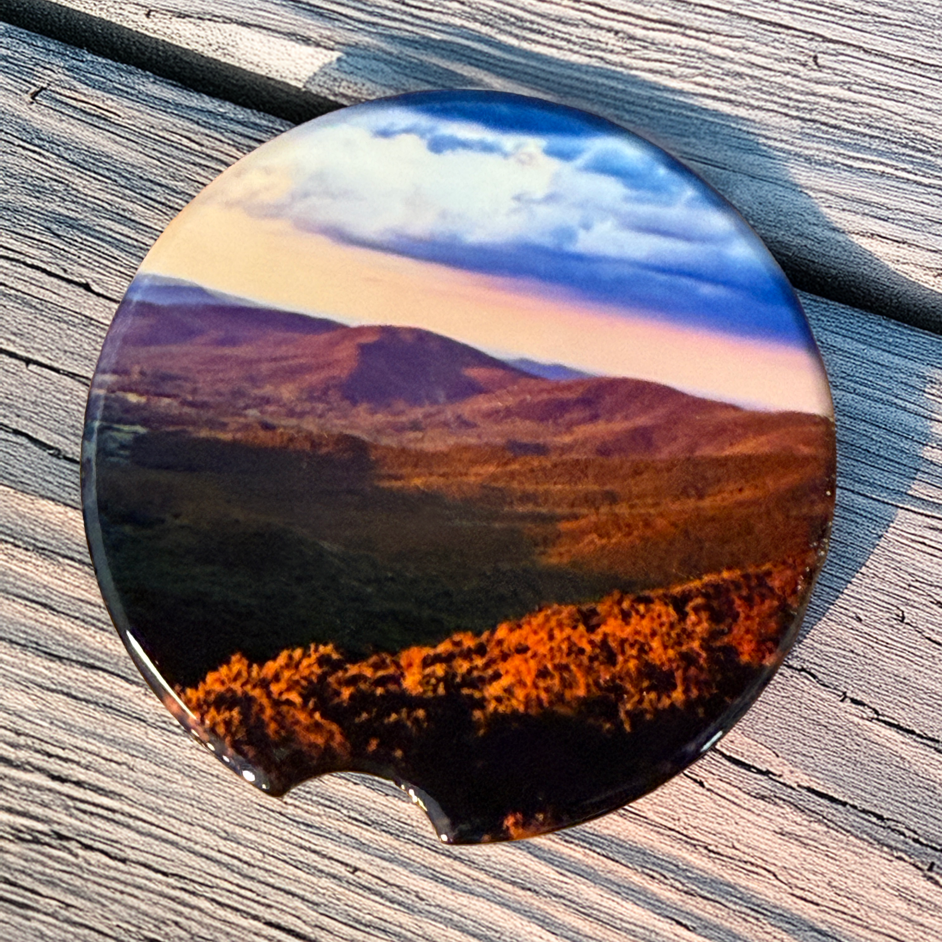 Ceramic car coaster featuring a sunset view from Hogback Overlook along Skyline Drive in Shenandoah National Park with rolling Blue Ridge Mountain scenery.