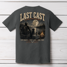Fishing artwork featuring an angler and dog by a campfire beside a moonlit lake with Last Cast slogan
