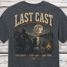 Last Cast fishing graphic t-shirt on Comfort Colors garment-dyed tee featuring a fisherman, loyal dog, moonlit lake, and campfire scene