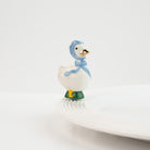 Nora Fleming Porch Pal goose mini wearing blue bonnet on Nora Fleming platter