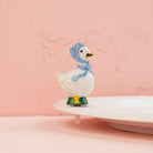 Nora Fleming Porch Pal goose mini wearing blue bonnet on Nora Fleming platter