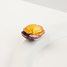 Nora Fleming Pansy Pop Mini featuring a vibrant hand-painted pansy flower displayed on a white serving piece