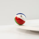 Front view of the Nora Fleming Beach, Please! Mini showcasing bright beach ball details and vibrant summer colors
