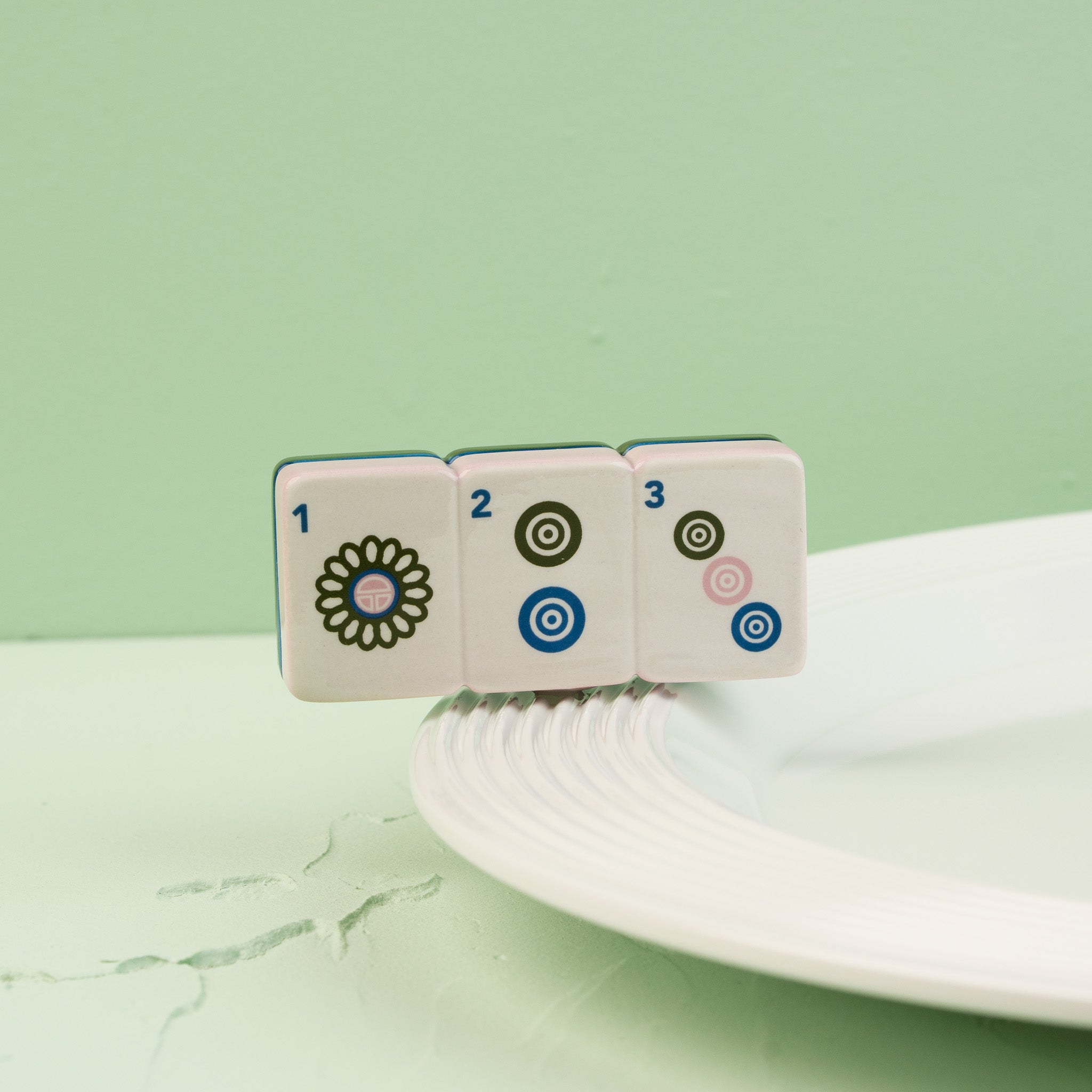 Nora Fleming Mahj-ical Mini displayed on a white Nora Fleming platter, perfect for Mahjong enthusiasts and game night entertaining