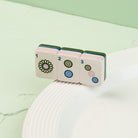 Nora Fleming Mahj-ical Mini featuring detailed Mahjong tiles displayed on a white serving piece
