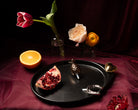 Nora Fleming Plato Ovalado Gift Set with metallic minis arranged on the black oval serving platter