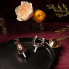 Nora Fleming Plato Ovalado Gift Set featuring black oval platter with three metallic minis displayed on an elegant tablescape