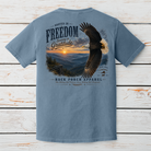 Rooted In Freedom graphic t-shirt on Comfort Colors garment-dyed tee featuring a soaring bald eagle above a Blue Ridge Mountain sunrise