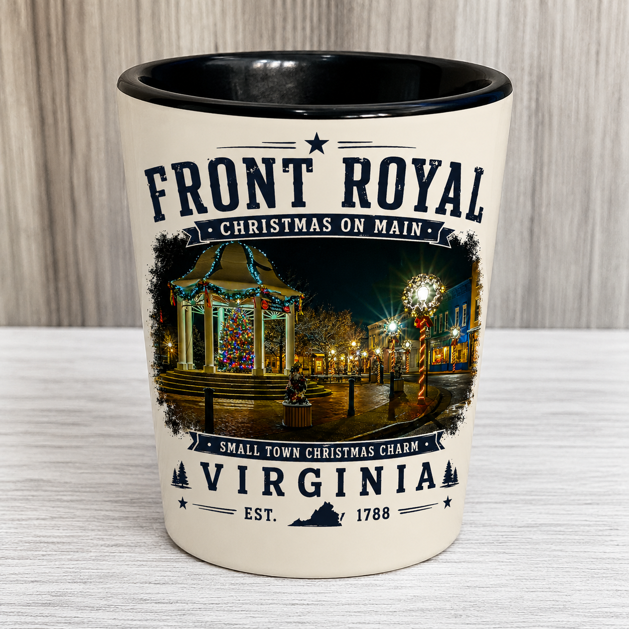 Front Royal Christmas on Main ceramic shot glass featuring the decorated gazebo, Christmas tree, and festive holiday lights in Front Royal, Virginia.