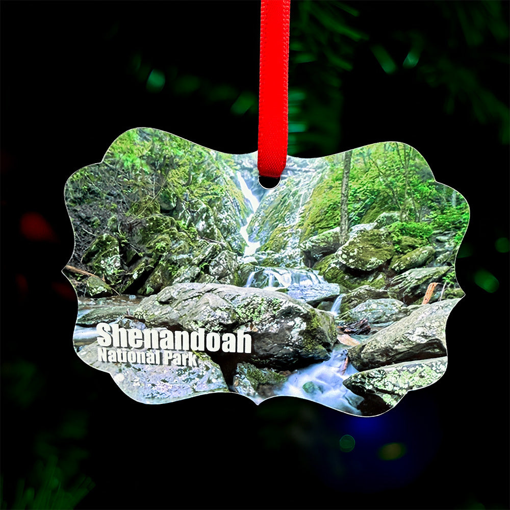 Shenandoah National Park waterfall metal ornament with red ribbon, featuring forest stream and cascading waterfall on front and park map with coordinates on back
